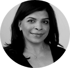 A black and white photo of a woman smiling.