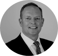 A black and white photo of a man in suit