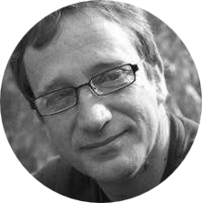 A black and white photo of a man with glasses.